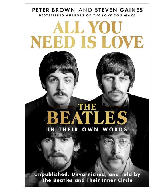 Cover of "All You Need Is Love, The Beatles in Their Own Words" with black and white pictures of Paul McCartney, Ringo Starr, George Harrison and John Lennon. The title is written in gold lettering.