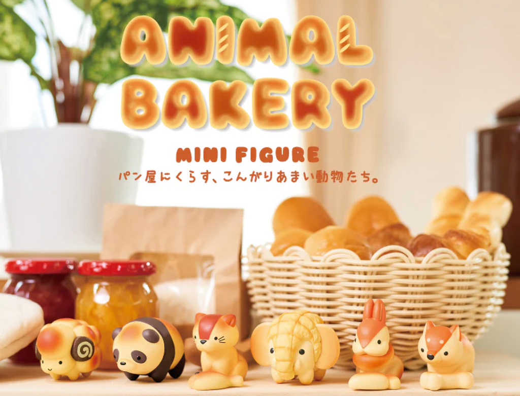 Each of the Animal Bakery mini figures lined up in front a basket of freshly baked bread and jam.