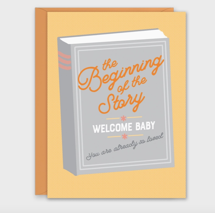 Greeting card with golden yellow background with an illustrated storybook with "The Beginning of the Story, Welcome Baby you are already so loved" written on the front.