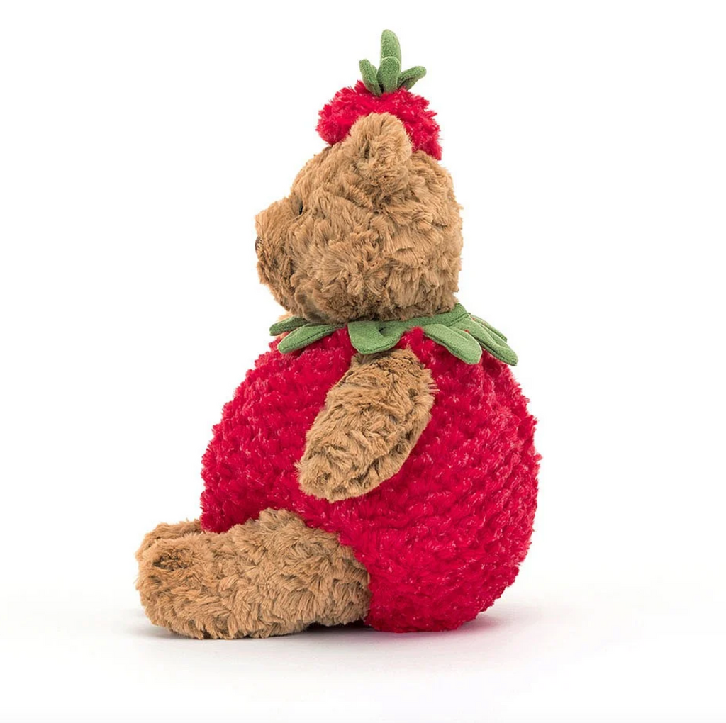 Side view of Bartholomew Bear wearing a strawberry.