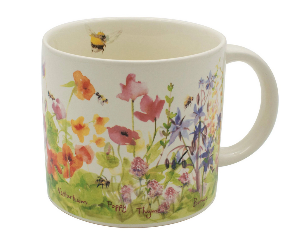 Close up of the Bee Garden Mug with colorful flowers on the outside and a bee painted on the inside of the  mug.