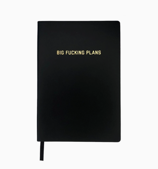Black vegan leather bound journal with gold foiled lettering that reads "Big Fucking Plans"