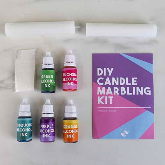 The contents of the Candle Marbling Kit, which include colored alcohol inks, candles and instruction book. 