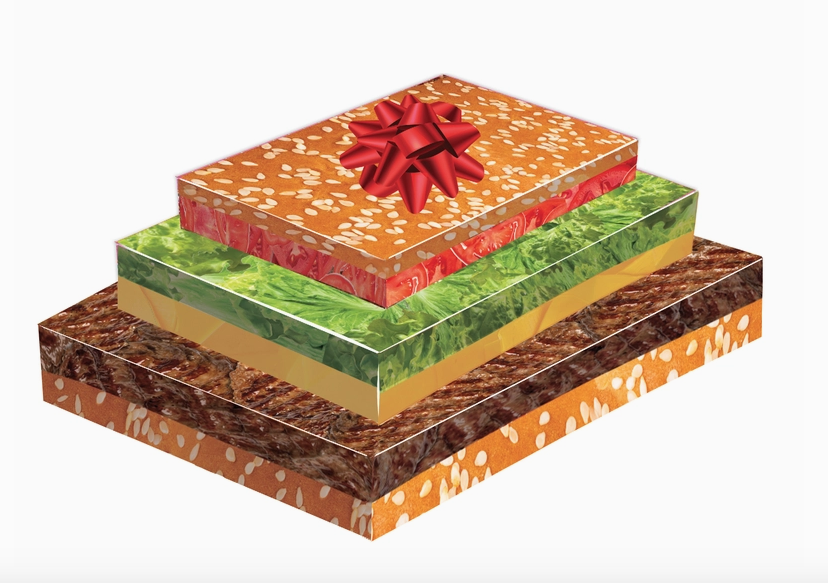 Three gift boxes stacked together. The bottom layer looks like the bottom bun and burger, the middle box looks like a slice of cheese and lettuce, and the top box looks like a tomato and seasame seed bun.