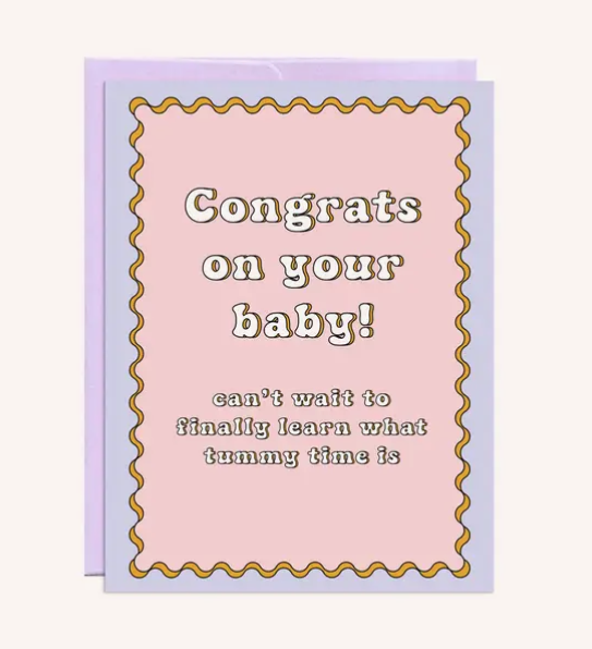 Greeting card cover with "Congrats on your baby! can't wait to finally learn what tummy time is" written on a background of pink and blue.