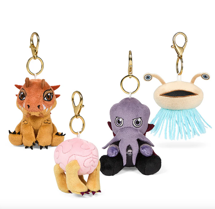 Plush Dungeons and Dragons charms of the characters Mind Flayer, Flumph, Tarrasque, and Intellect Devourer. 