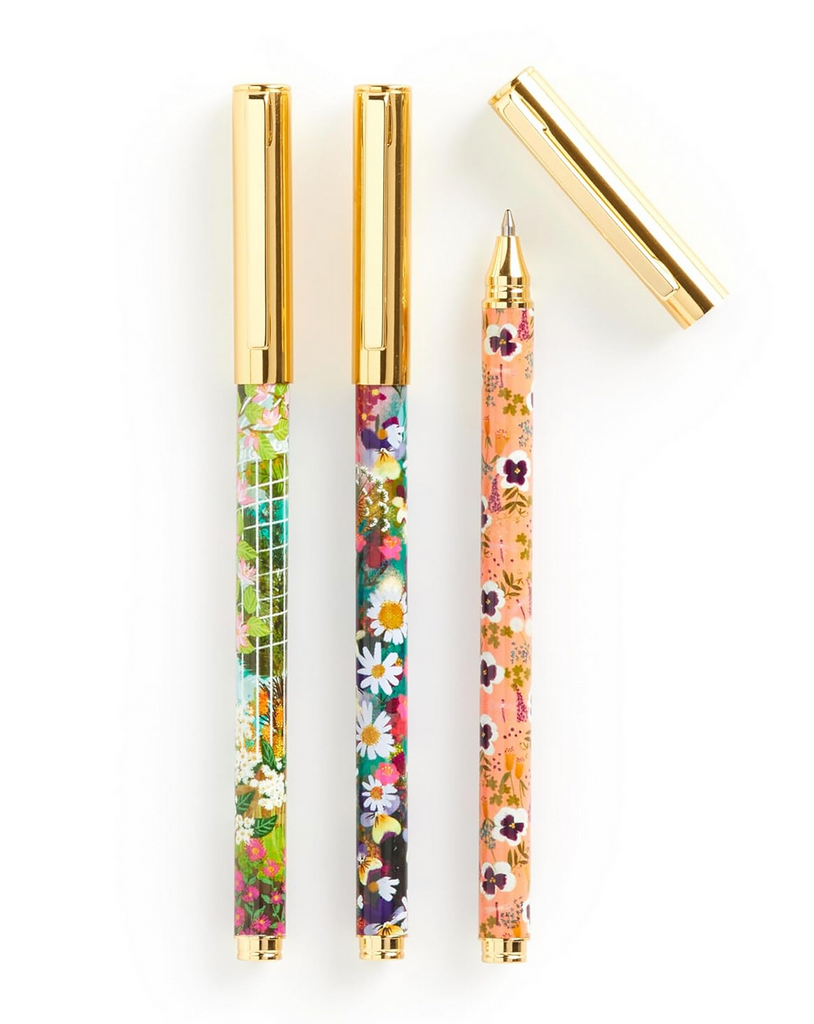 Three pens with different floral patterns on each. With gold tops.