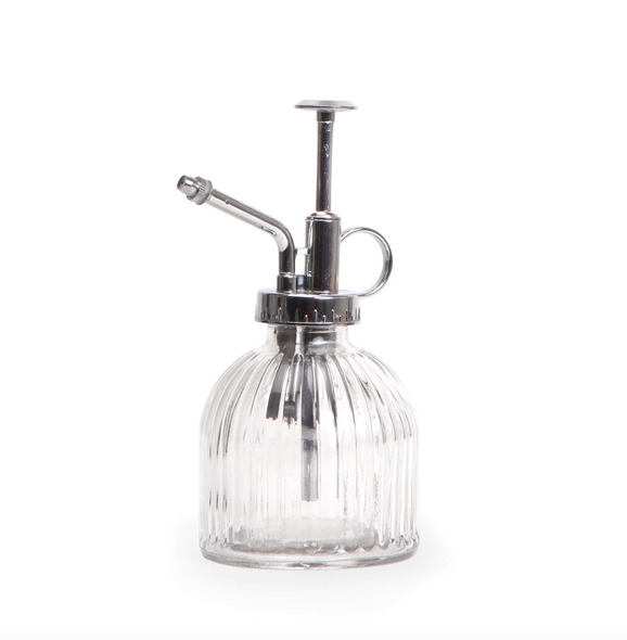 Close up of the clear glass mister bottle with silver pump, nozzle and handle.  