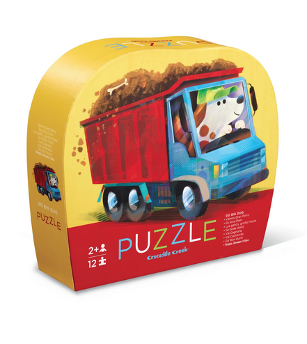 Shaped puzzle box with illustration of  a dog driving a dump truck on the cover.