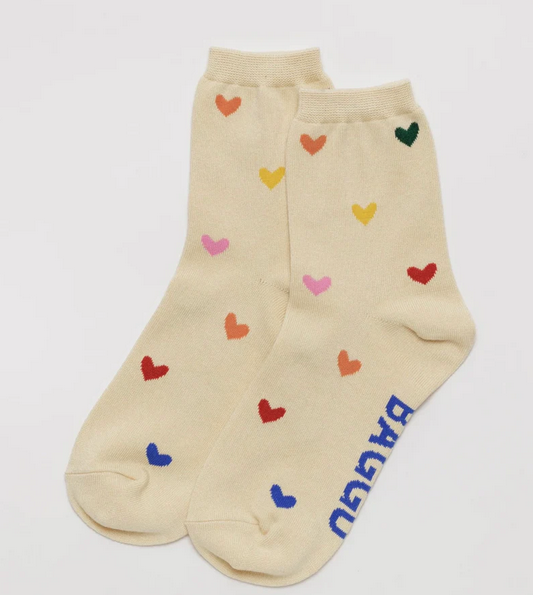 Cream colored crew socks with multi colored hearts all over the socks.