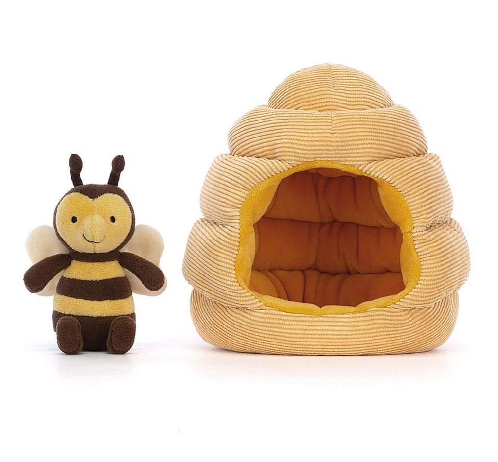 Plush brown and yellow striped bumble bee sitiing beside it's plush honeycomb house.