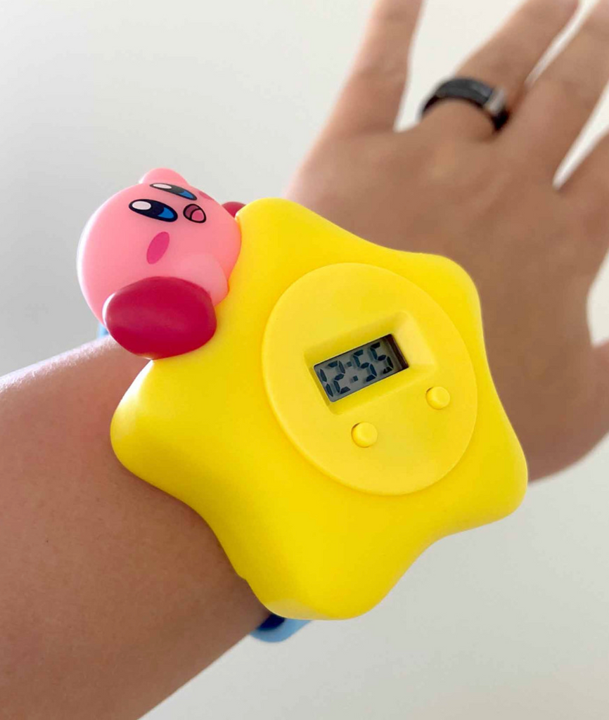 Close up of the Warp Star Kirby digital watch on a wrist.