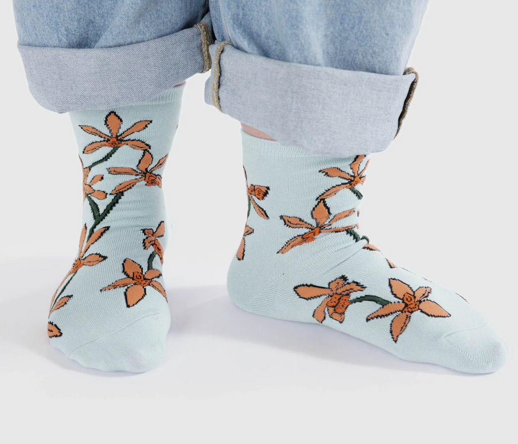 A pair of feet wearing the Orchid Crew Socks.