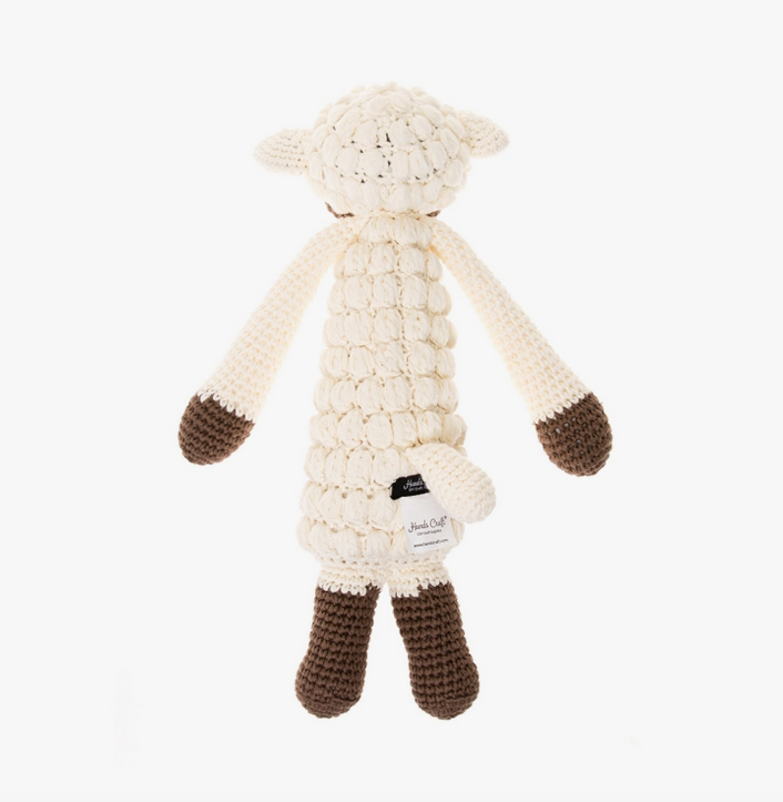 Rear view of Poppy Standing crochet doll, with cream white body and brown legs and paws. 