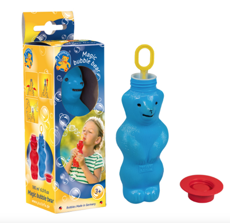 Magic Bubble Blowing Bear in blue with the bubble wand up. The box with an open window to see the bears face is beside it. 