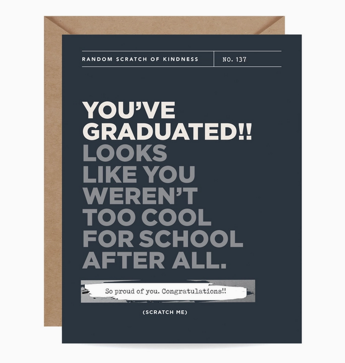 Black greeting card with white and silver block lettering that reads "You've Graduated! Looks Like You Weren't Too Cool For School After All." There is a scartch off area to reveal a secret message.
