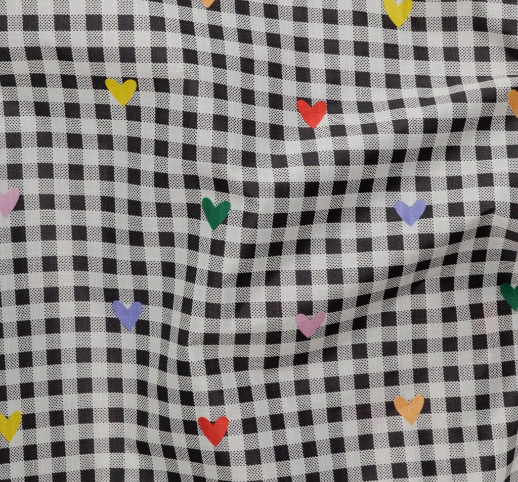 Close up of the black and white gingham with multicolored hearts print from Baggu.