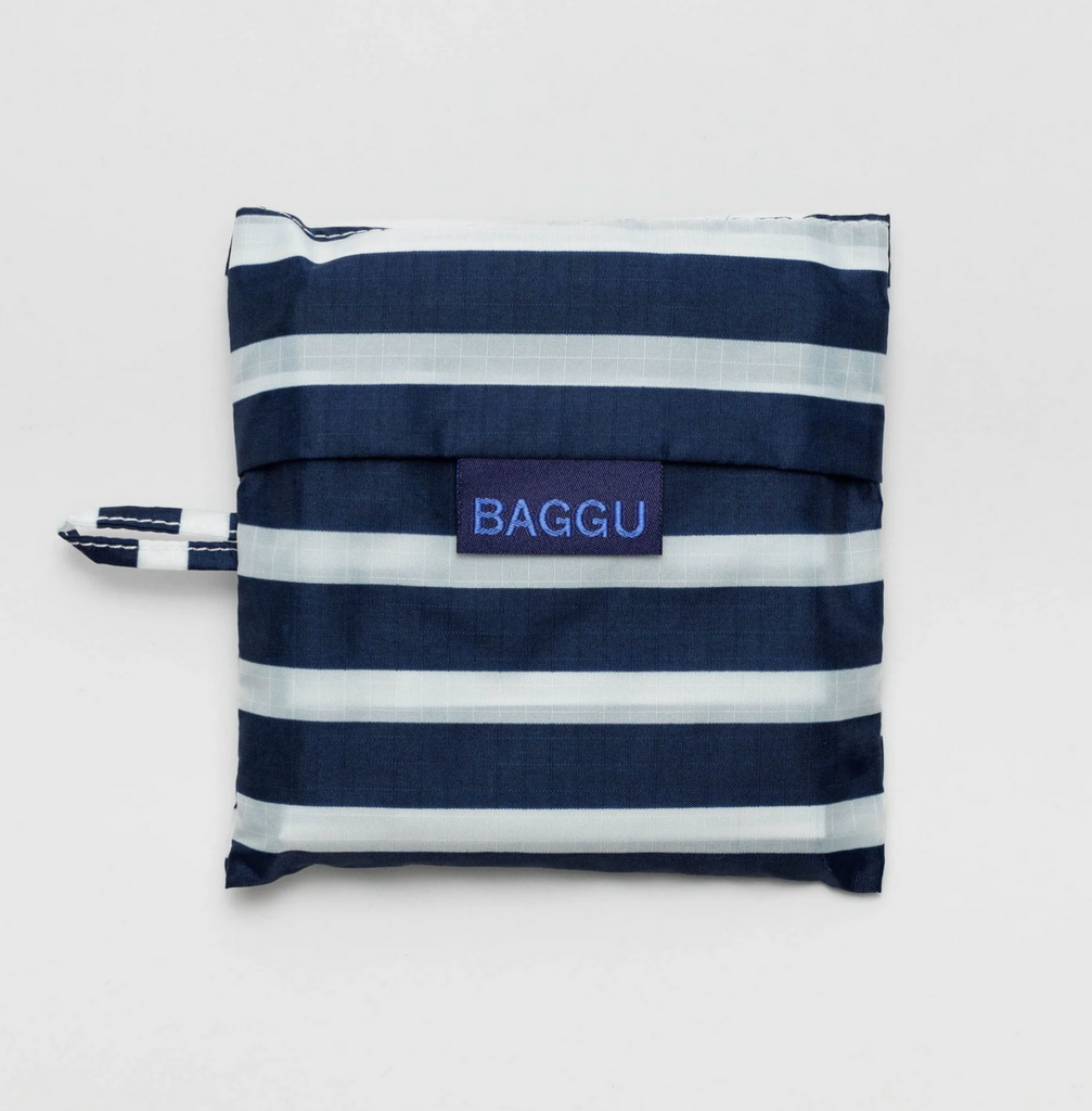 Navy and white standard Baggu folded in it's matching pouch.