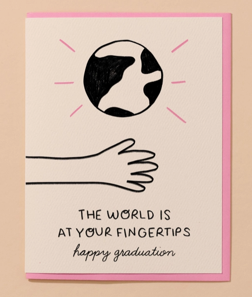 Greeting card with black and white illustration of earth with an arm reaching out. It reads "The World Is At Your Fingertips. Happy Graduation"