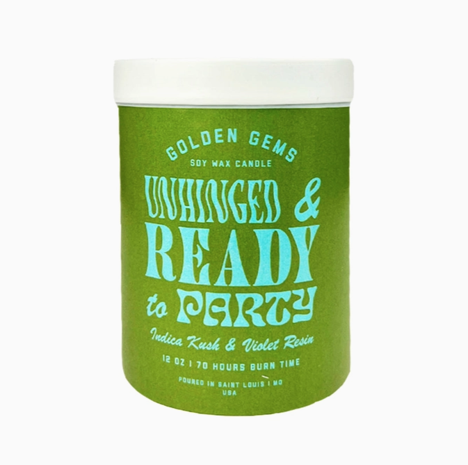 Green jar with light blue lettering that reads " Unhinged & Ready to Party" "Indica Kush & Violet Resin" A white top covers the candle. 