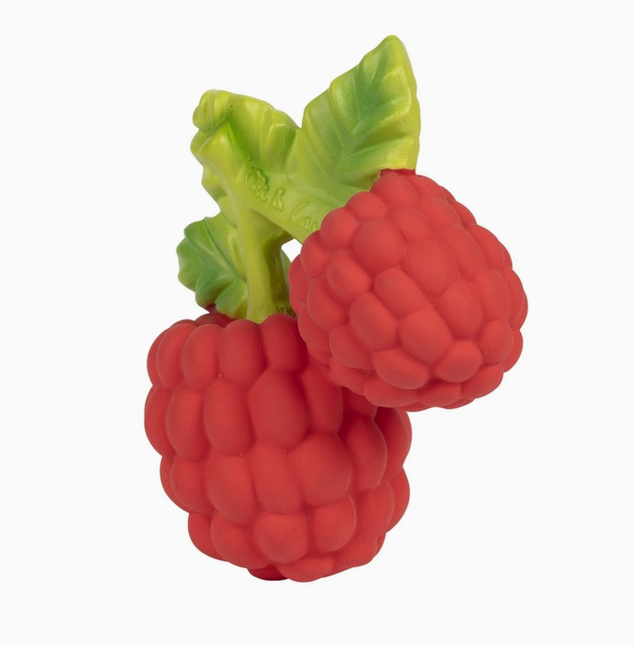 Close up view of Valery the Raspberry teether toy with two red berries hanging from green leaves. 