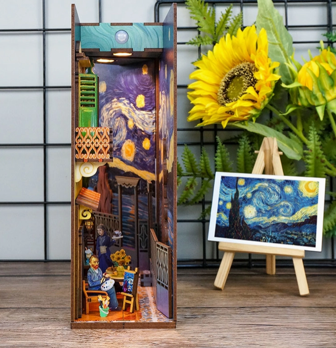 A view into the completed 3D puzzle of Vincent's World, with  Starry Night like images on the walls and painter sitting at a cafe painting. Depicting what Vincent Van Gogh's world may have looked like. 