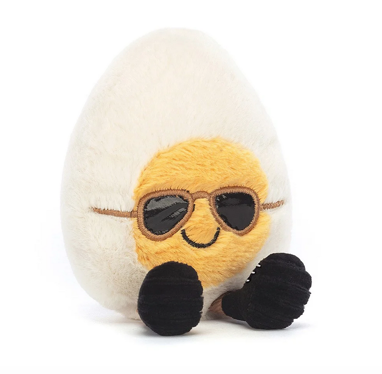 Plush boiled egg with yellow yolk face wearing sunglasses and a cool smile. 