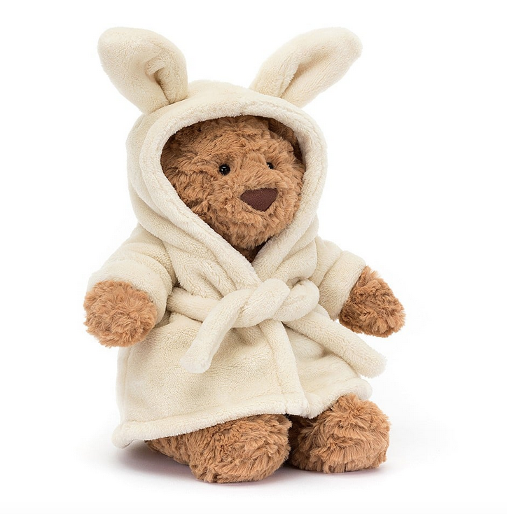 Bartholomew Bear wearing a soft white hooded robe with bunny ears. 