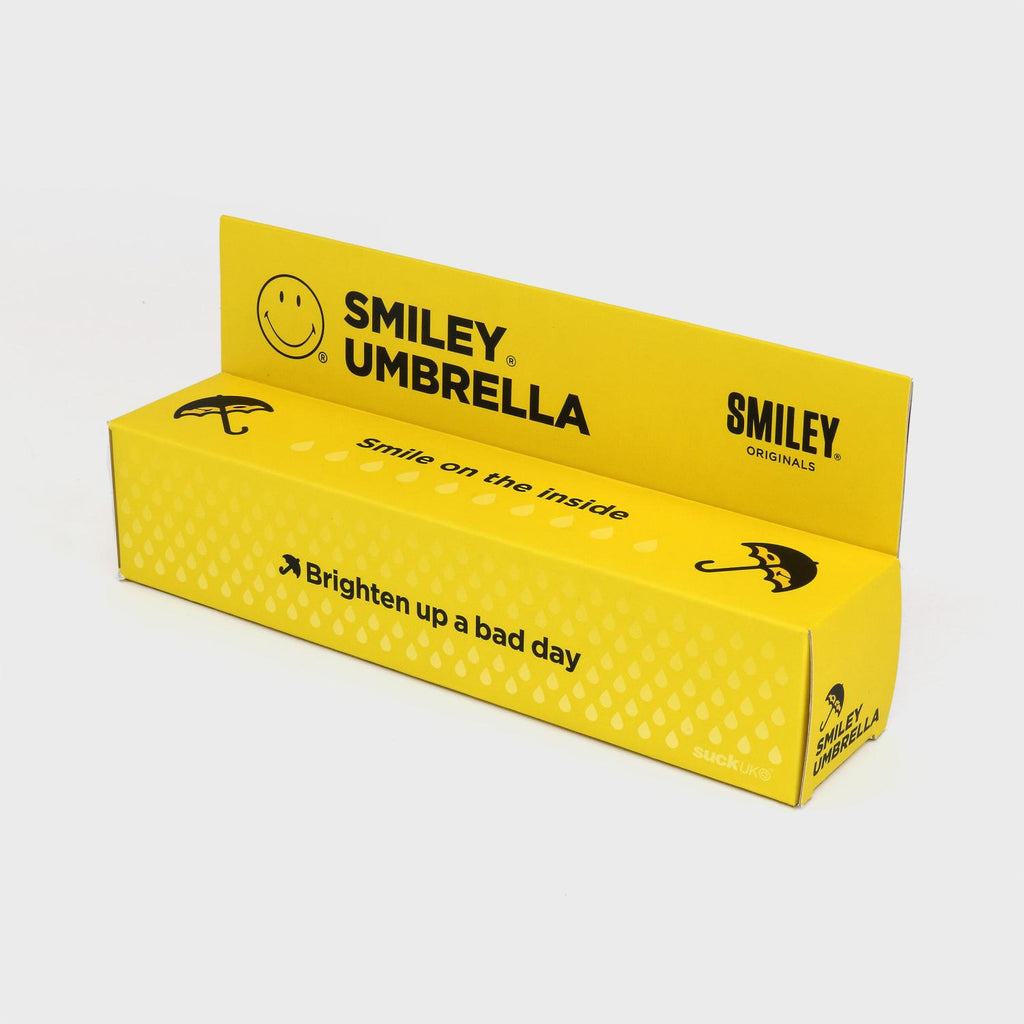 Bright yellow box with black lettering that reads "Smiley Umbrella"  "Smile on the inside" and "Brighten up a bad day" 