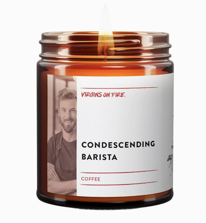 Soy wax candle in brown glass jar with wrap around white label with black lettering that reads "Condescending Barista" with picture of a young man with a beard and an apron with his arms crossed. 
