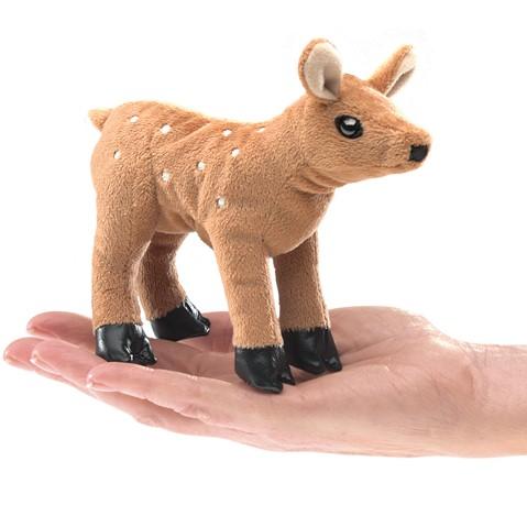 Fawn finger puppet with light brown fir and sweet white spots standing on the palm of a hand. 