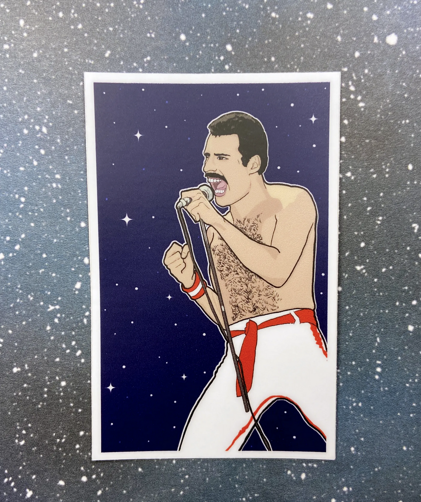 Sticker of Freddie Mercury from Queen shirtless in white pants and a red belt singing into a microphone in front of a blue background with white stars.
