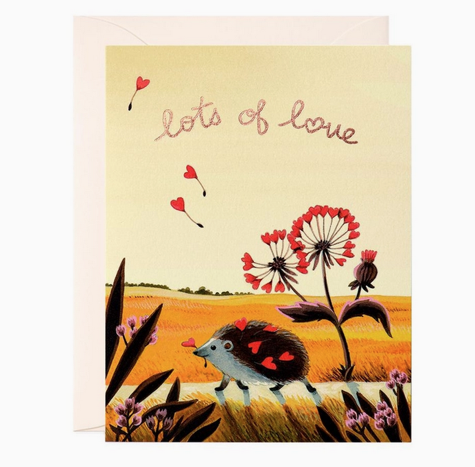 A hedgehog walking by a golden field with hearts in it's quills with the words "lots of love" 