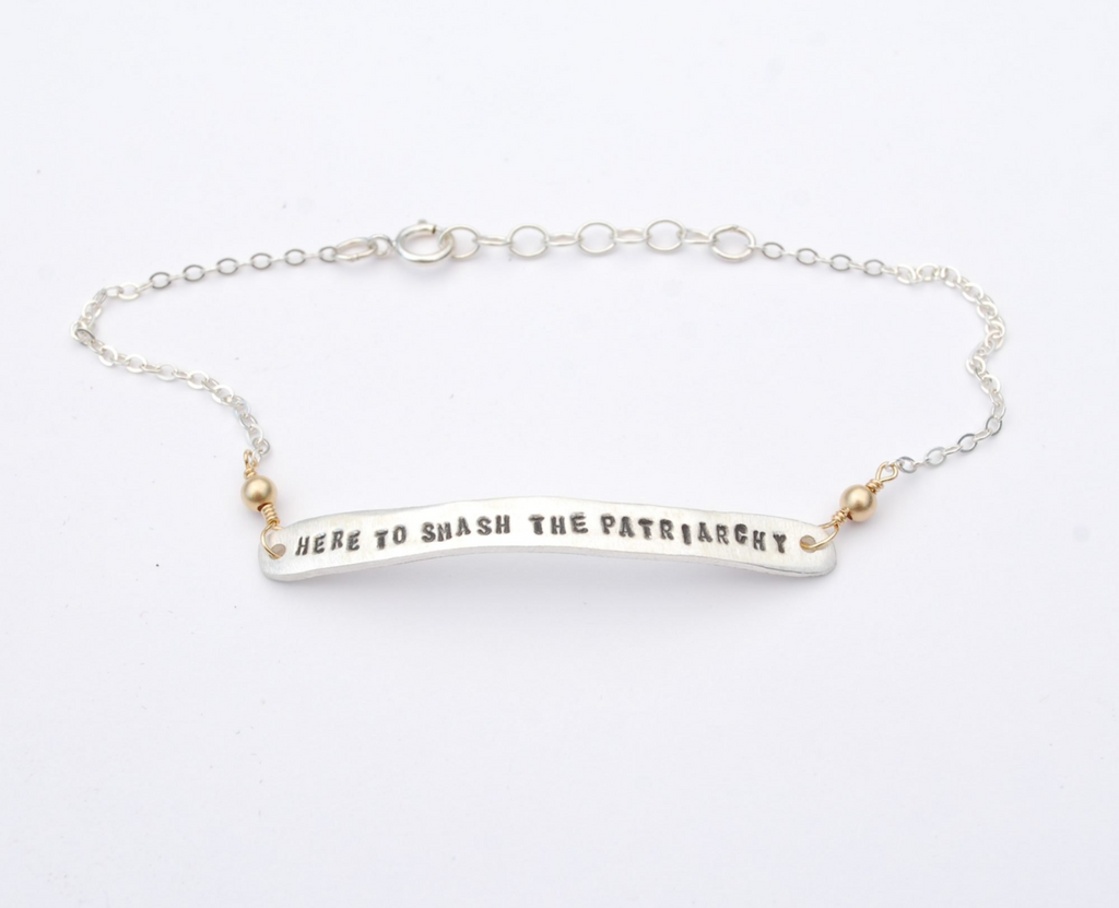 Silver chain bracelet with a silver bar stamped with Here To Smash the Patriarchy.