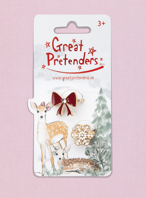 The Holiday Bow and Snowflake ring Set on a hang card with a winter scene on it. 