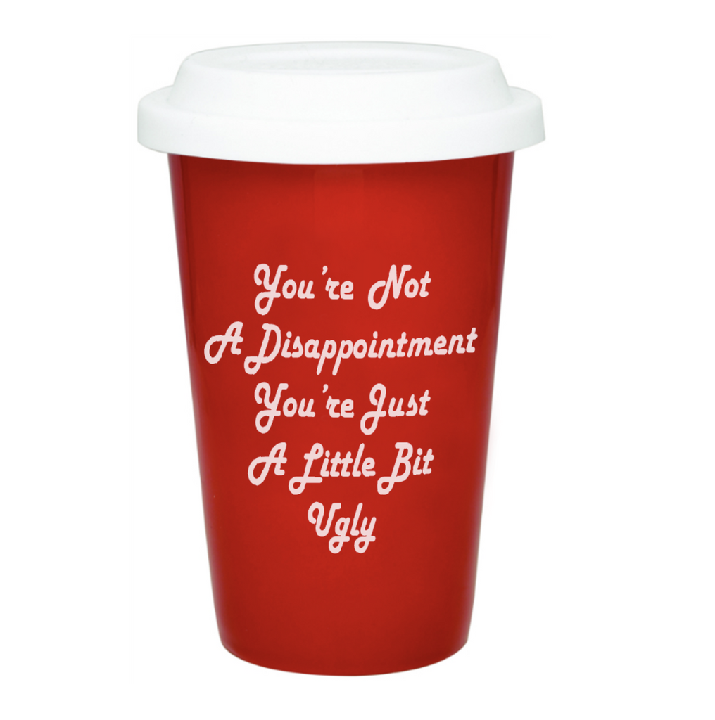 red ceramic tumbler with white silicone lid. White text reads "You're not a disappointment you're just a little bit ugly."