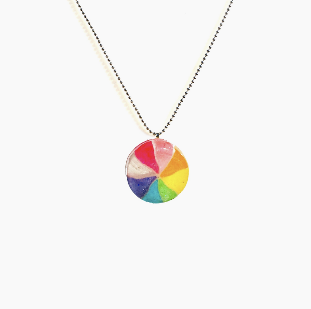 Real rainbow pinwheel candy dipped in resin on a silver bead necklace.