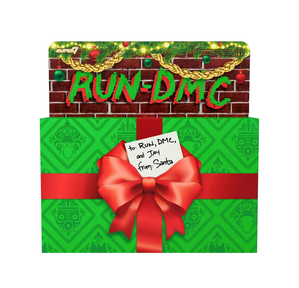 Festive box for RUN DMC 3 pack figure set. Looks like a wrapped package with bow. 