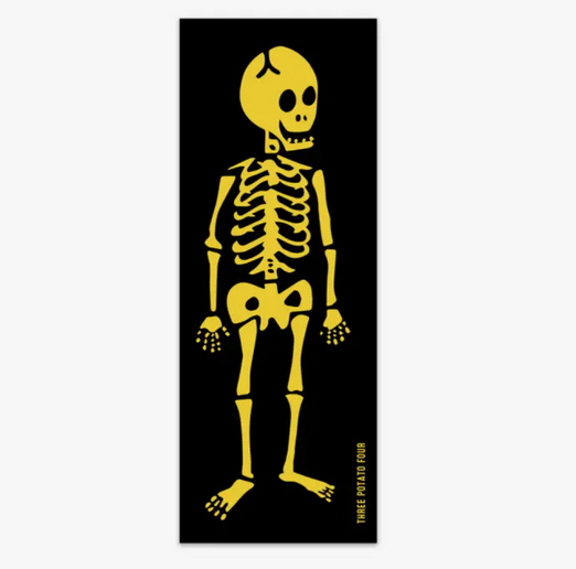 Vertical rectangle sticker with a yellow skeleton on a black background. 