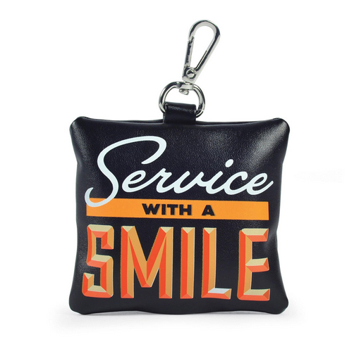 Black doggy poop bag holder with a metal clip. Bag reads Service With A Smile in white and orange.