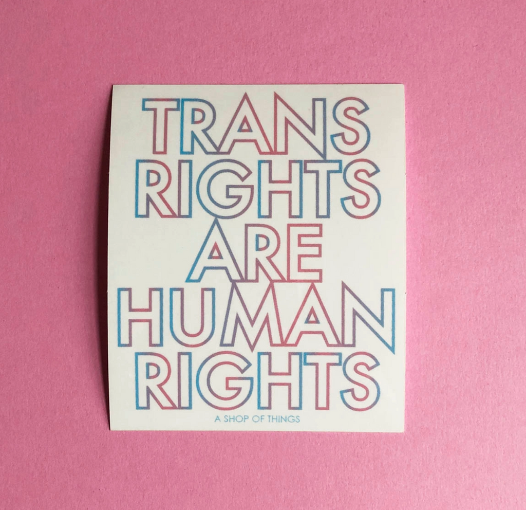 White square sticker that reads "Trans Rights Are Human Rights" in colors of the trans pride flag.
