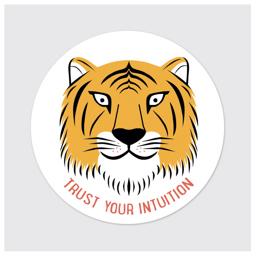 Round sticker of an illustrated tiger face with red text reading "Trust Your Intuition."
