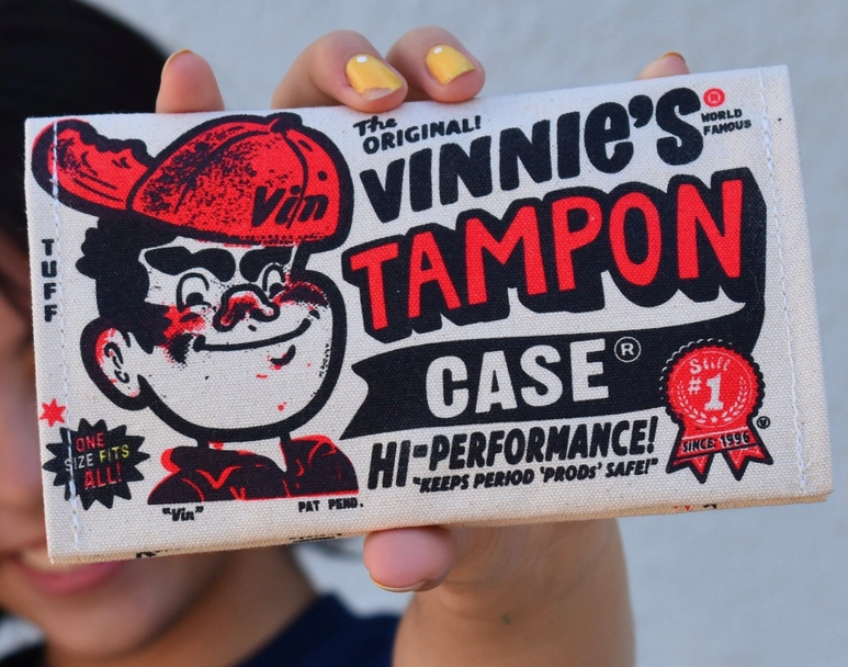 The front of Vinnie's Tampon Case with an illustration of Vinnie in his signature red cap. 