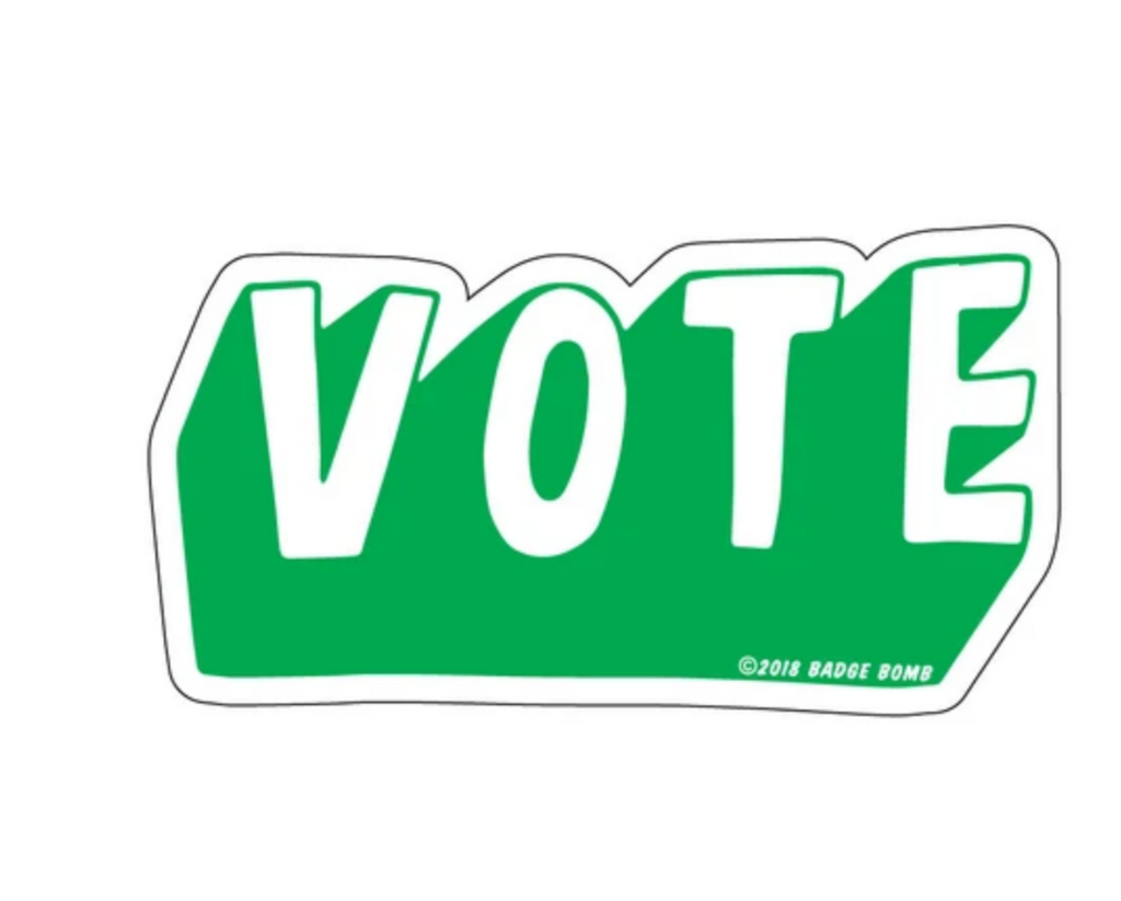 Green sticker that reads vote.