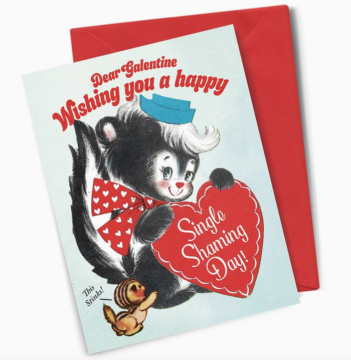 A cartoon illustrated skunk holding a heart, the card reads "Dear Galentine Wishing you a happy Single Shaming Day" 