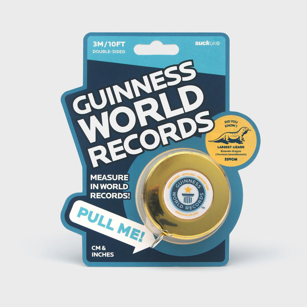 Blue cardboard hangcard with white lettering that reads "Guinness World Records" "Measure In World Records" with the gold tape measure attached under a clear plastic bubble. 