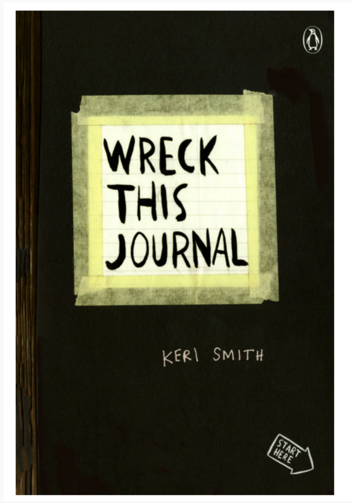 Image of Wreck This Journal book by Keri Smith. Book is black with lined paper reading Wreck This Journal in black font taped to cover. White arrow stating Start Here is located in bottom right corner.