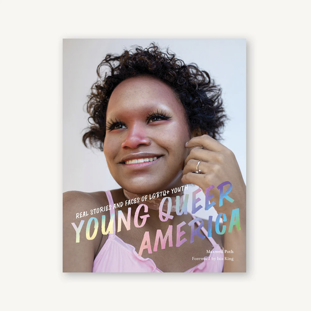 Cover of Young Queer America: Real Stories and Faces of LGBTQ+ Youth by Maxwell Poth with foreword by Isis King features a young person in a pink top looking off to the side with a big beautiful smile on their face.