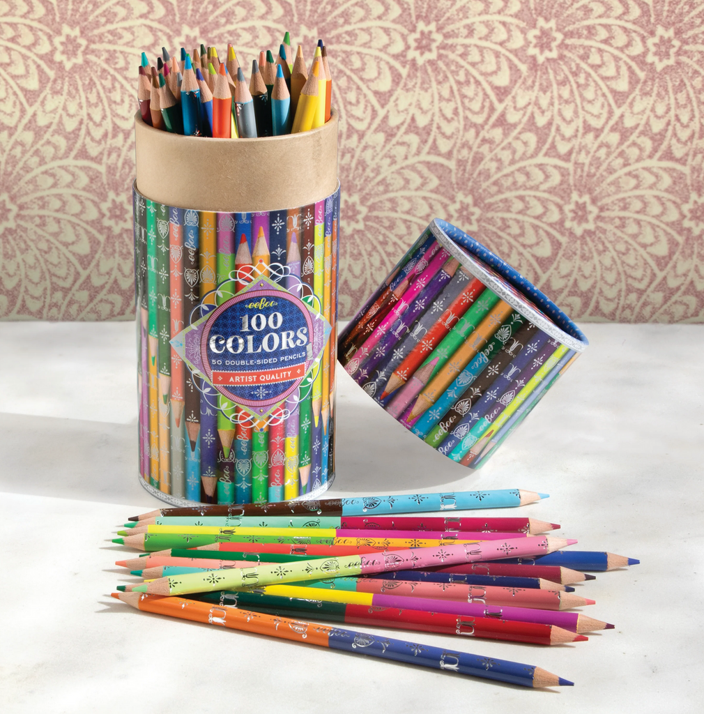 Opened tube of 100 colors 50 double sided pencils on a table with a selection of pencils displayed in front.