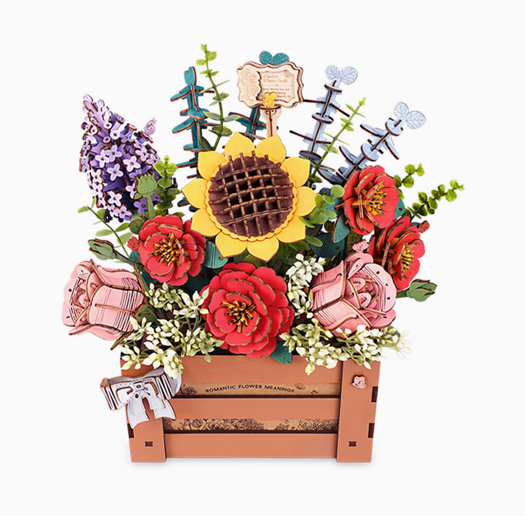 Wooden flower puzzles all displayed together in a wooden crate. Flowers include sunflower, lilacs, camellias and more!